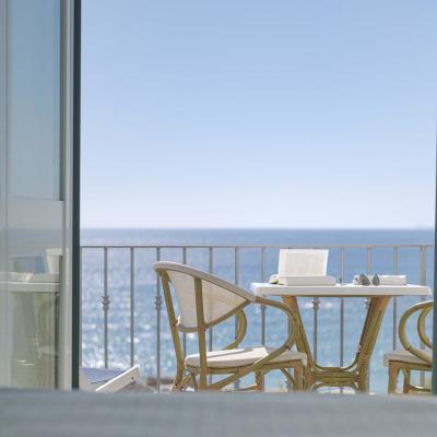 Sea view from a balcony, chairs and table invite relaxation.