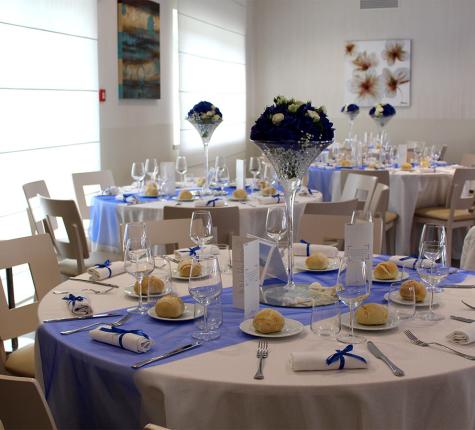 Elegant dining room with tables decorated in blue and white.