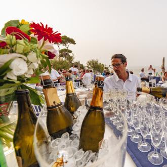 Outdoor party with champagne and sea view.