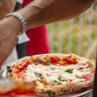 Freshly baked Margherita pizza with mozzarella and basil.