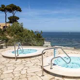 Two hot tubs with panoramic sea view.