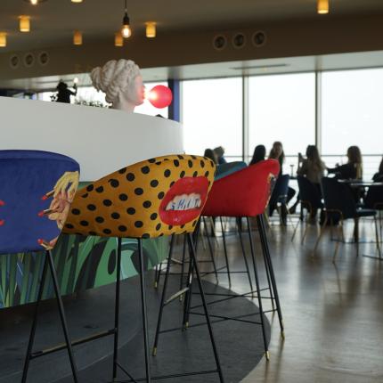 Bar with colorful chairs and panoramic view.