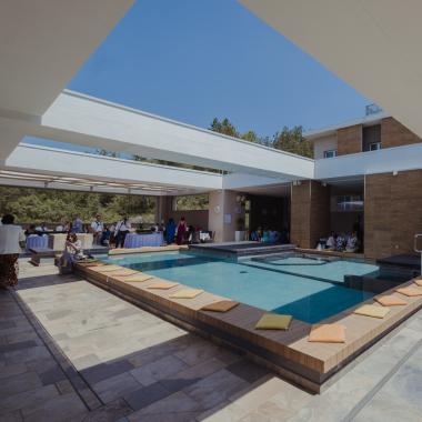 Piscina luminosa, gente rilassata, atmosfera elegante e accogliente.