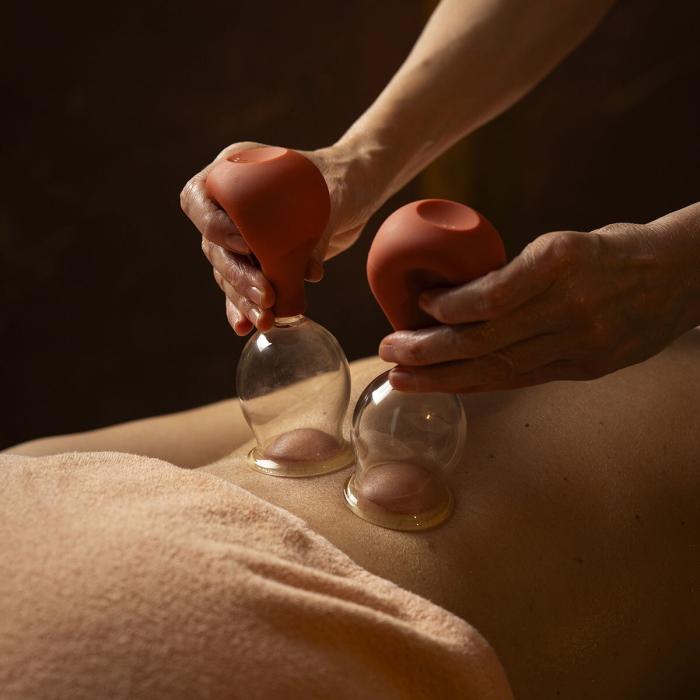 Relaxing cupping massage, skilled hands, enveloping warmth.