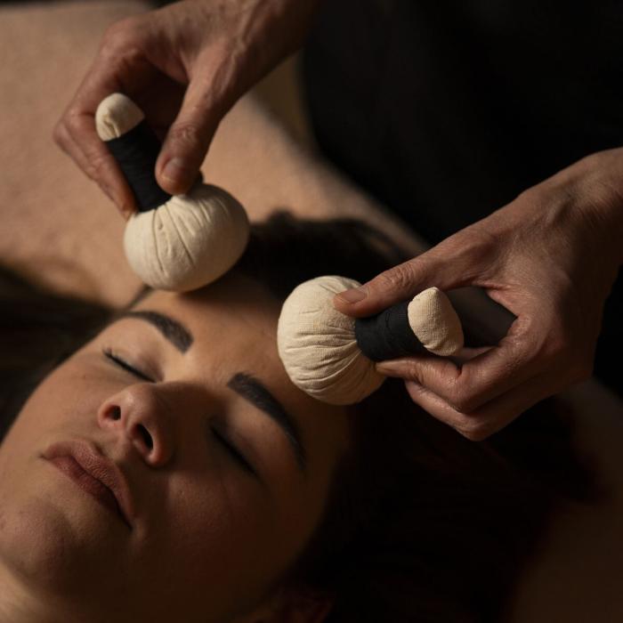 Relaxing facial massage with warm compresses, serene and soothing atmosphere.