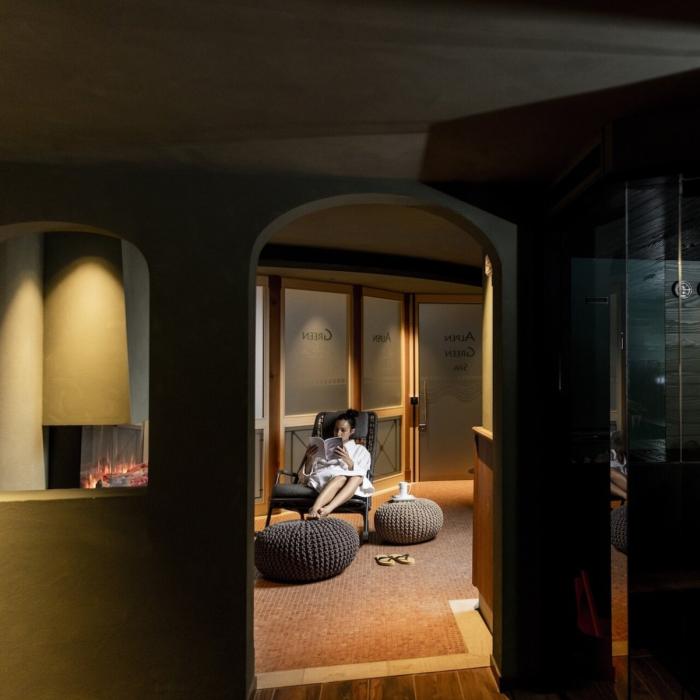 Relaxing spa ambiance with sauna and reading by the fireplace.