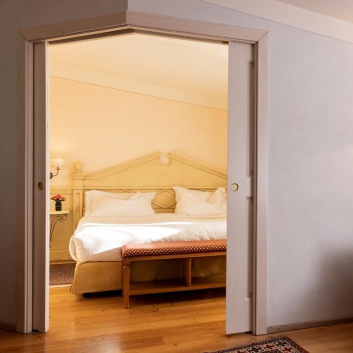 Cozy room, soft bed, warm light, comfy sofa, relaxing atmosphere.