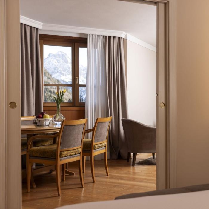 Alpine view from an elegant room, with table and flowers.