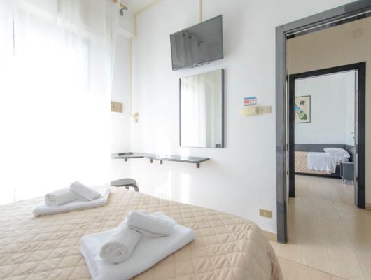Bright, cozy room with fresh linens and modern decor.