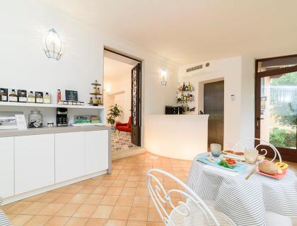 Bright breakfast room with set table and coffee corner.