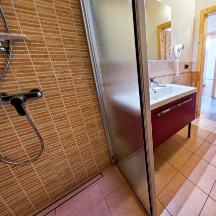 Bagno moderno con doccia, bidet e lavabo.