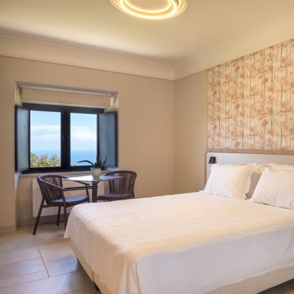 Bright room with sea view, elegant furnishings, and relaxing atmosphere.