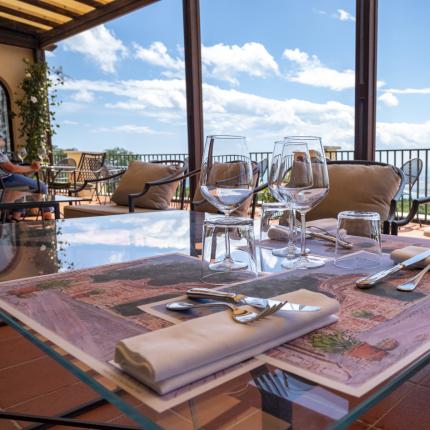 Scenic terrace, set table, blue sky, and fluffy clouds.