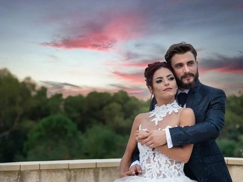 Couple embracing at sunset, romantic atmosphere.