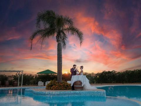 Romantic couple at sunset by the pool.