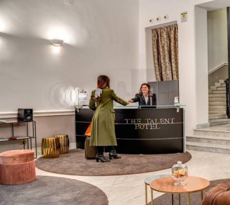 Elegant hotel reception with guests and an elevator.