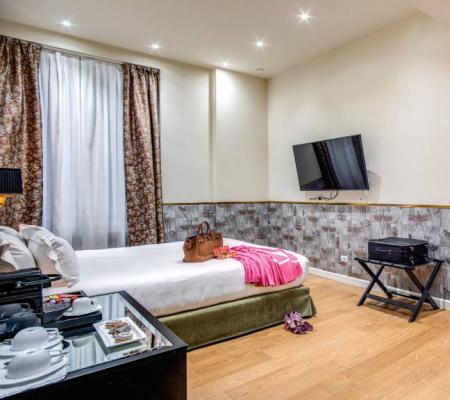 Modern room with bed, wall-mounted TV, and stylish decor.