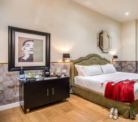 Elegant hotel room with a double bed and refined decor.