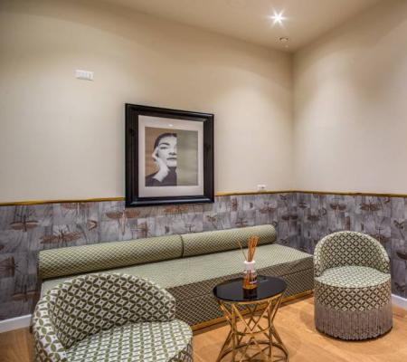 Elegant living room with modern furniture and black-and-white photos on the walls.