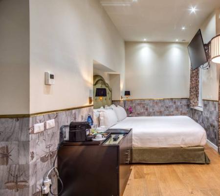Modern room with double bed and elegant decor.