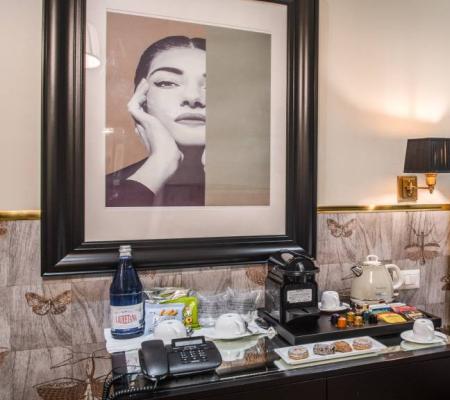 Elegant hotel room with coffee and water.