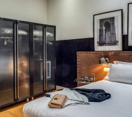 Modern room with bed, wardrobe, and artwork.