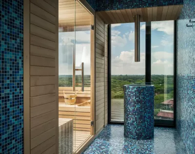 Sauna moderna con vista panoramica e mosaico blu.