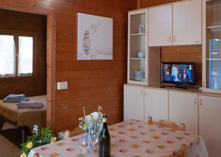 Cozy wooden home, set table, warm and relaxing atmosphere.