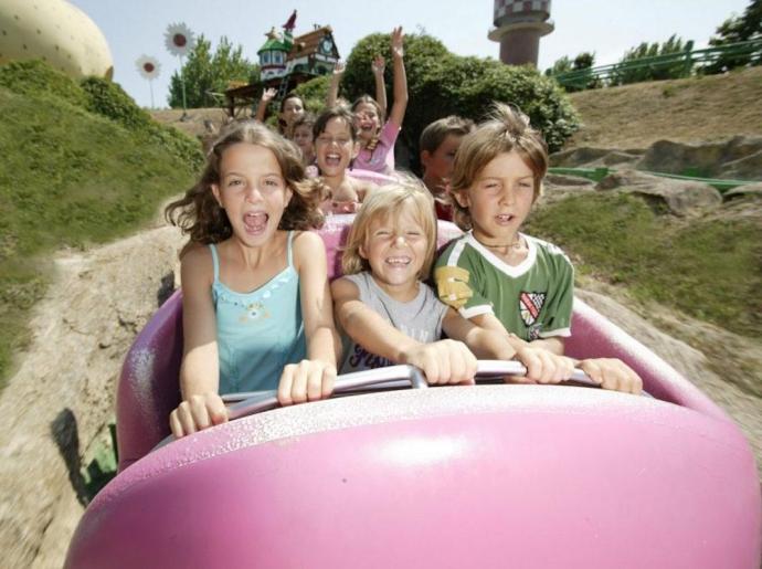 Children enjoying a ride at a theme park.