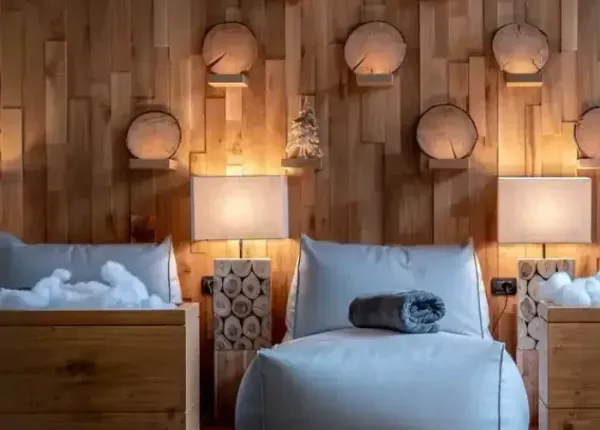 Cozy room with wooden walls and natural decorations.